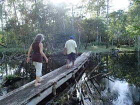 Bocas del Toro narrow wodden bridge with people on it – Best Places In The World To Retire – International Living